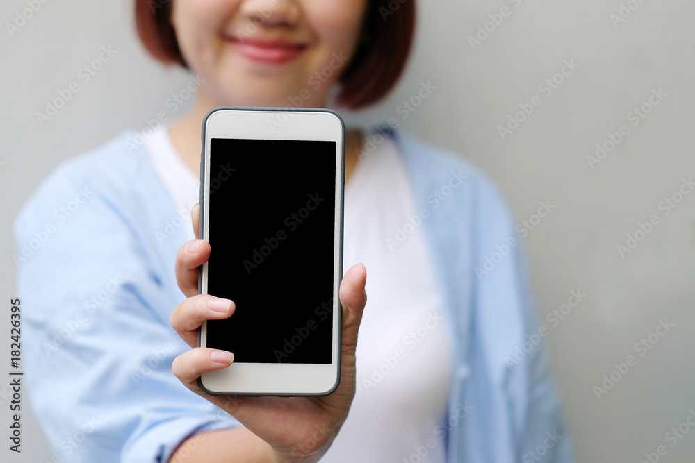 Woman hands holding smart phone with blank screen background for mock up, template, technology and lifestyle concept