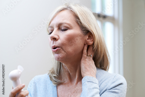 Mature Woman Experiencing Hot Flush From Menopause photo