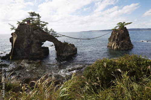 Hatago Iwa rocks joined by shimenawa rope, Noto Peninsula, Japan photo