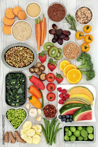 Fototapeta Naklejka Na Ścianę i Meble -  Vegetarian super food concept of fresh fruit, vegetables, cereals, grains, pulses, herbs and spice. Health food with foods high in antioxidants, minerals, fibre, smart carbohydrates and protein.