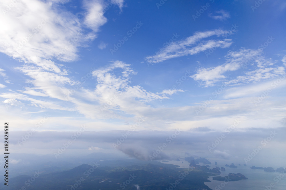 Aerial view from window air plane and top views of Phang Nga Bay and blue sky and cloud, phuket island before landing at Phuket, thailand