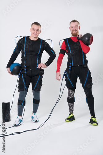 Two men in an electric muscular suit for stimulation. photo