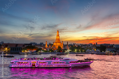 Wat Arun and cruise ship in twilight time, Bangkok city, Thailand photo