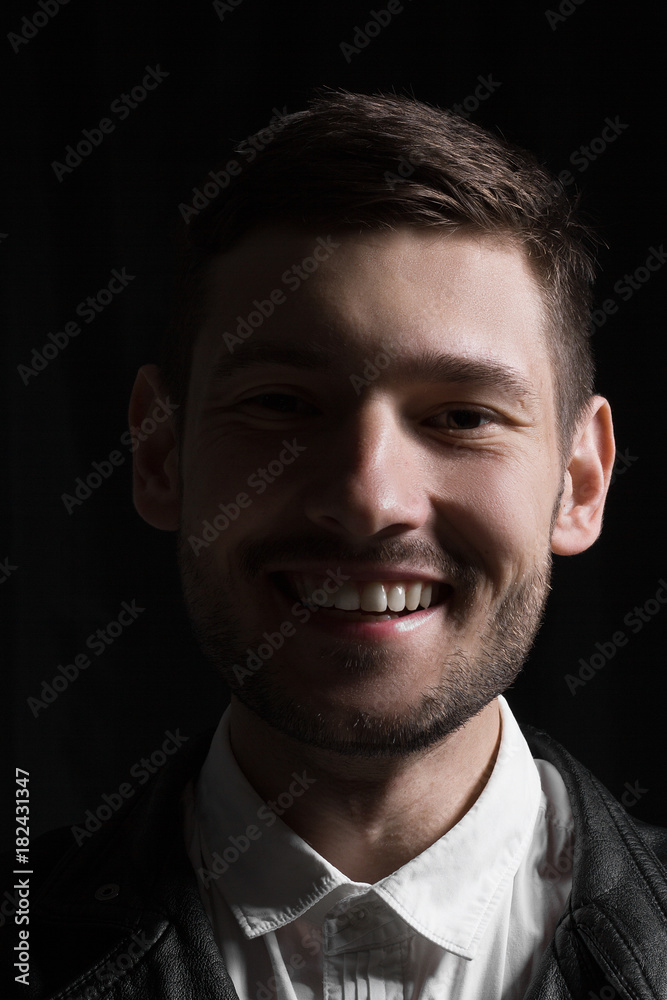 Male portrait in leather jacket in studio