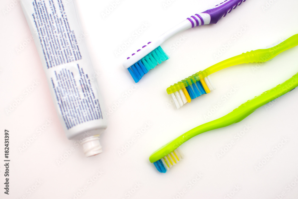 On a white background lies toothpaste and brush On a white background lies toothpaste and brush
