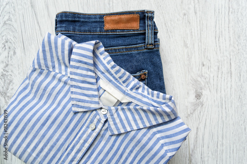Classical striped shirt and blue jeans. Fashionable concept