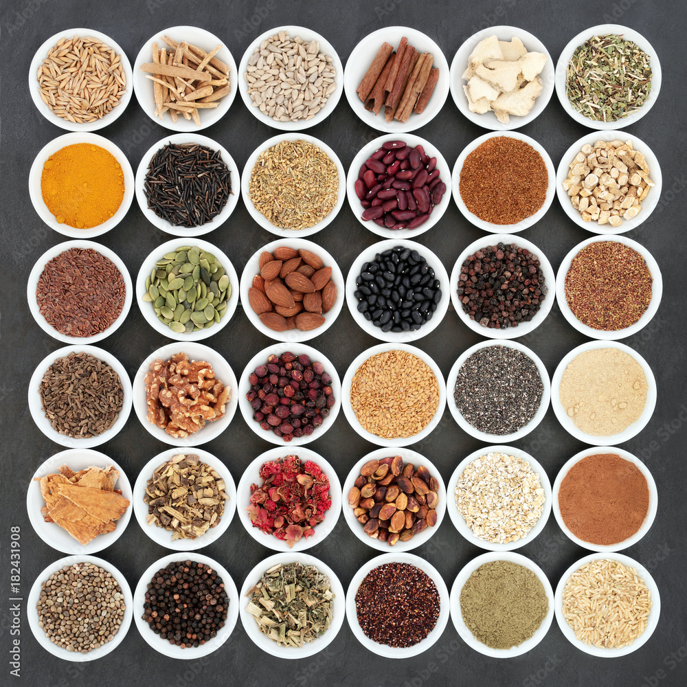 Herbal medicine and food ingredients to maintain a healthy heart. Large collection in porcelain bowls on slate background. Top view. Herbal medicine and food ingredients to maintain a healthy heart. Large collection in porcelain bowls on slate background. Top view.