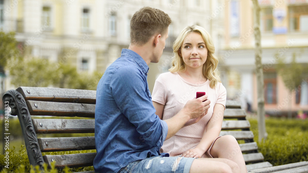 Young woman rejecting boyfriends proposal, disappointed with engagement ring Young woman rejecting boyfriends proposal, disappointed with engagement ring