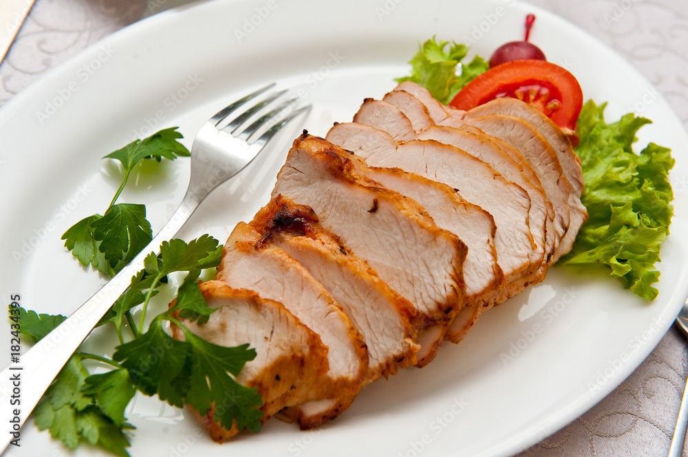Pork sliced with lettuce and tomato leaves