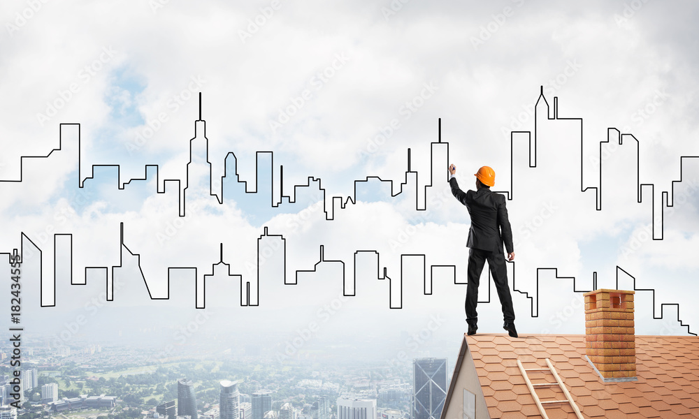 Man architect draw silhouette of modern city on blue sky. Mixed media Man architect draw silhouette of modern city on blue sky. Mixed media