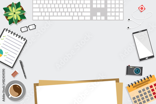 Top view of table working and working desk with gadget and free space for text with accessory on the table, notebook, keyboard, pencil, pen, coffee cup, glasses, flowerpot, camera, note