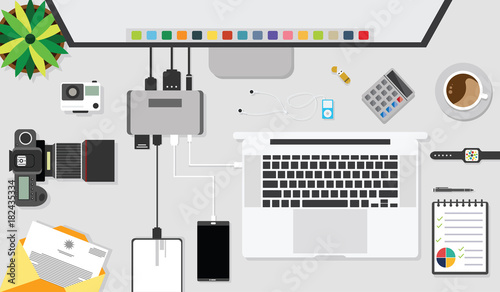 Top view of table working with gadget and working desk with accessory on the table, laptop, notebook, desktop, phone, flash drive, coffee cup, letter, flowerpot, note, camera, pen, calculator