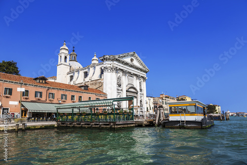 View of the church of Gesuati or Santa Maria del Rosario from the Grand Canal, the cafe and the vaporetto stop "Zattere". Venice. Italy.