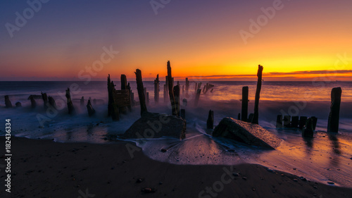 Old Spurn Point beach sea defences at sunrise photo