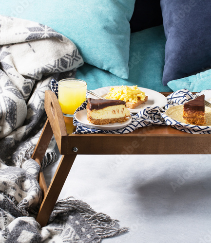 Breakfast in bed for two, scrambled eggs, cheesecake, morning, vertical, selective focus