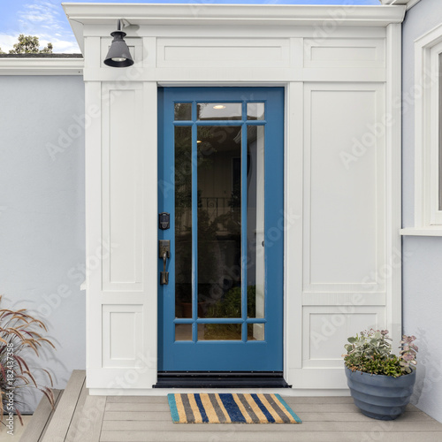 Glass Entry Door. Front door in Lively Blue with framed glass and electronic lock entry. © coralimages