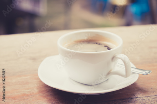 Black coffee on the wood table. (vintage tone)