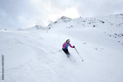 Female back-country skier downhill skiing from Piz Laschadurella, Sesvenna Alps, Engadin, Graubuenden, Switzerland