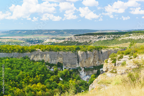 Landscape view on the natural boundary of Mariam-Dere  Canyon of Maria   Holy assumption Orthodox cave monastery and the town of Bakhchisaray on the horizon