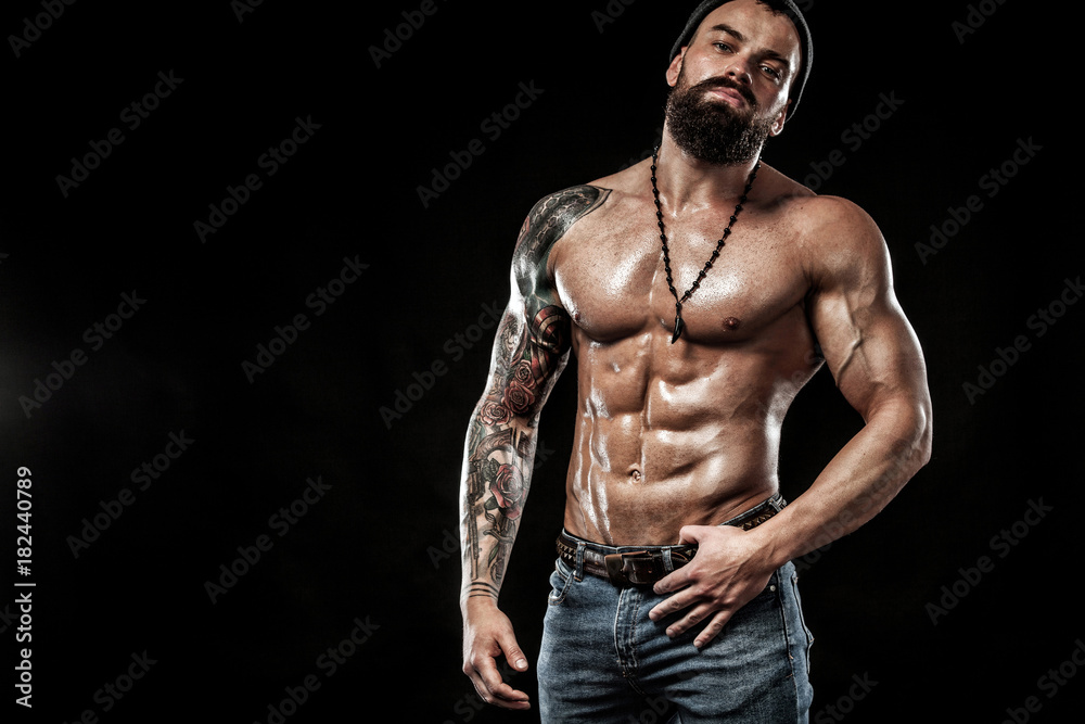 Bodybuilder posing. Beautiful sporty guy male power. Fitness muscled man. Spot concept with copy space Bodybuilder posing. Beautiful sporty guy male power. Fitness muscled man. Spot concept with copy space
