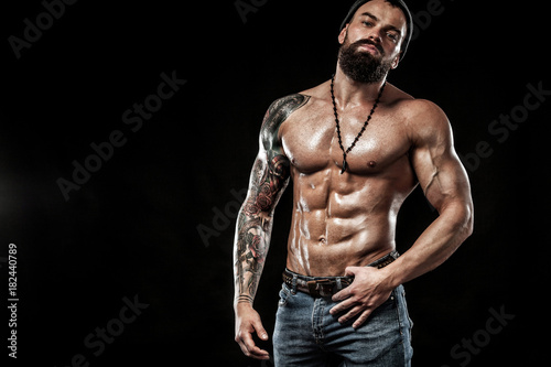 Bodybuilder posing. Beautiful sporty guy male power. Fitness muscled man. Spot concept with copy space