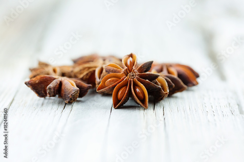 Illicium verum, star anise, staranise, star anise seed, Chinese star anise, or badiam on wooden table. Studio light, selective focus. photo