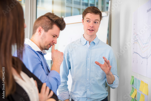 Businessman Gesturing While Communicating With Colleagues