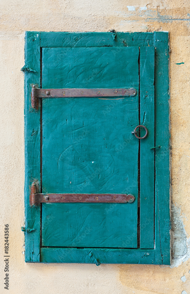 Blue wooden window shutters of a old mediterranean house