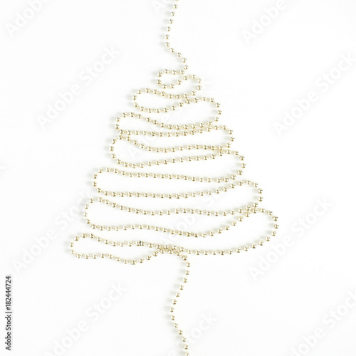 Christmas tree made of golden garland on white background. Flat lay, top view minimal holiday concept.