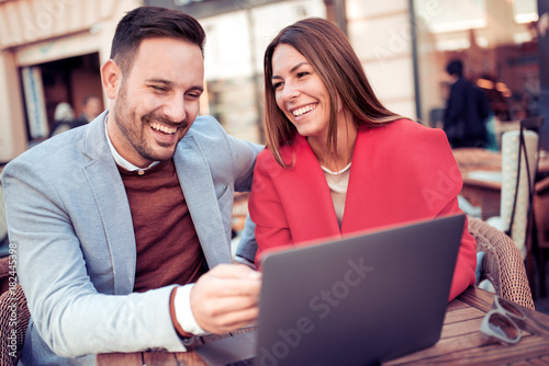 Beautiful young couple using laptop