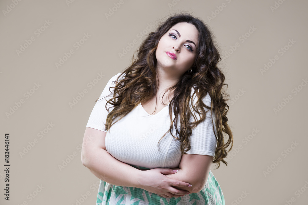 Plus size fashion model, sexy fat woman on beige background Plus size fashion model, sexy fat woman on beige background