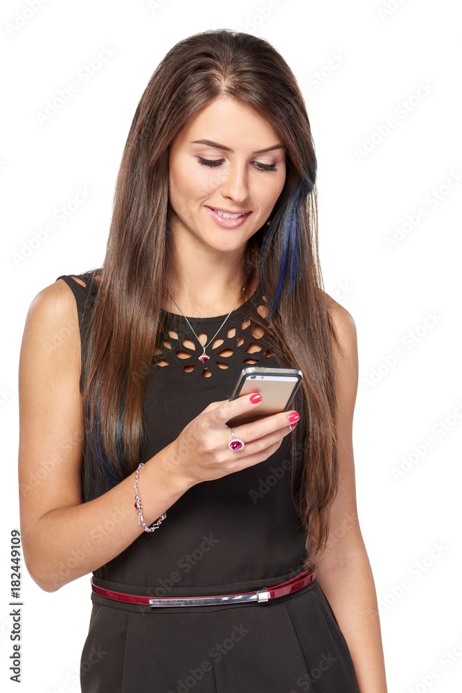 Businesswoman in black texting in smartphone smiling over white background Businesswoman in black texting in smartphone smiling over white background