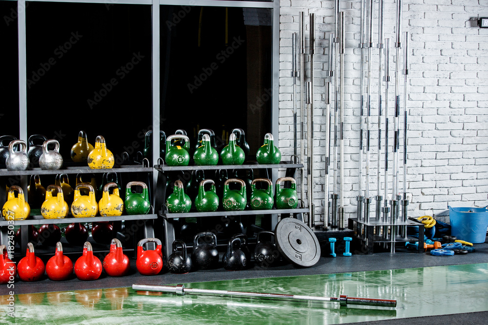 A gym with inventory on the background of a window and a gray wall