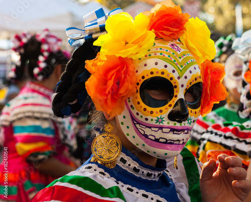 Canvastavla Portrait of girl wearing colorful skull mask and paper flowers for Dia de Los Mu
