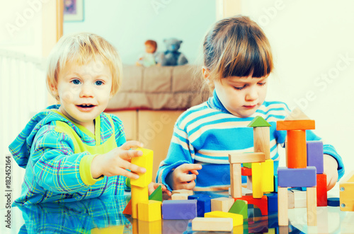  happy children playing with  toys in home