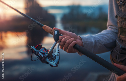 Angler enjoys in fishing on the river, closeup photo. Sport, recreation, lifestyle