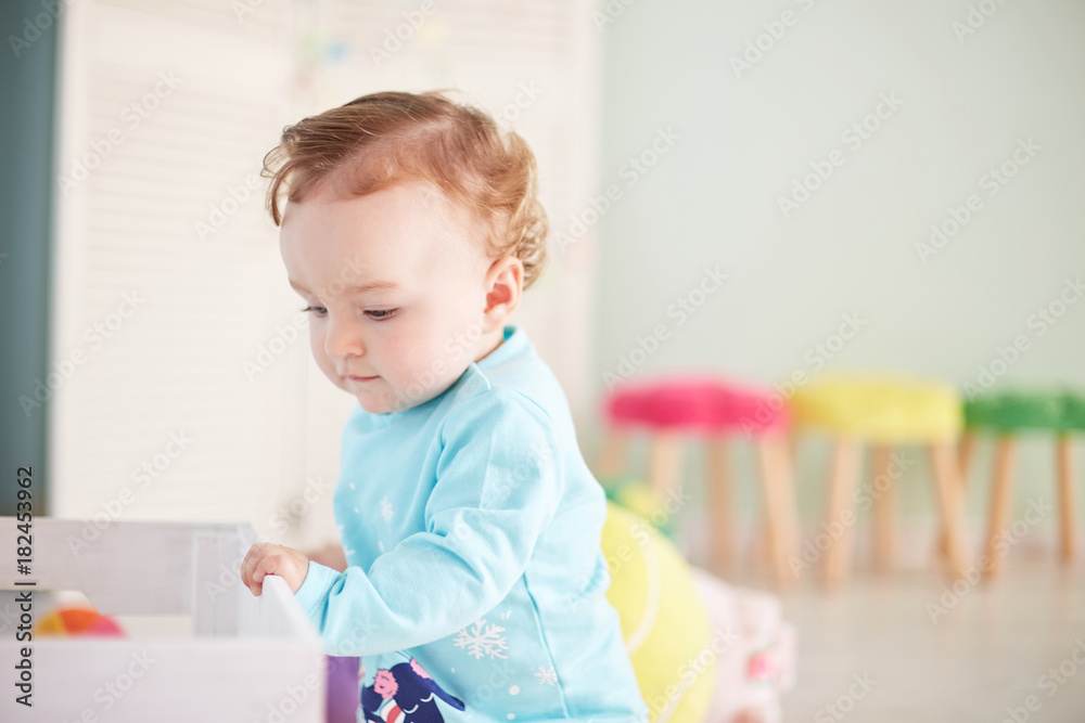 little child is playing with toys in the studio little child is playing with toys in the studio