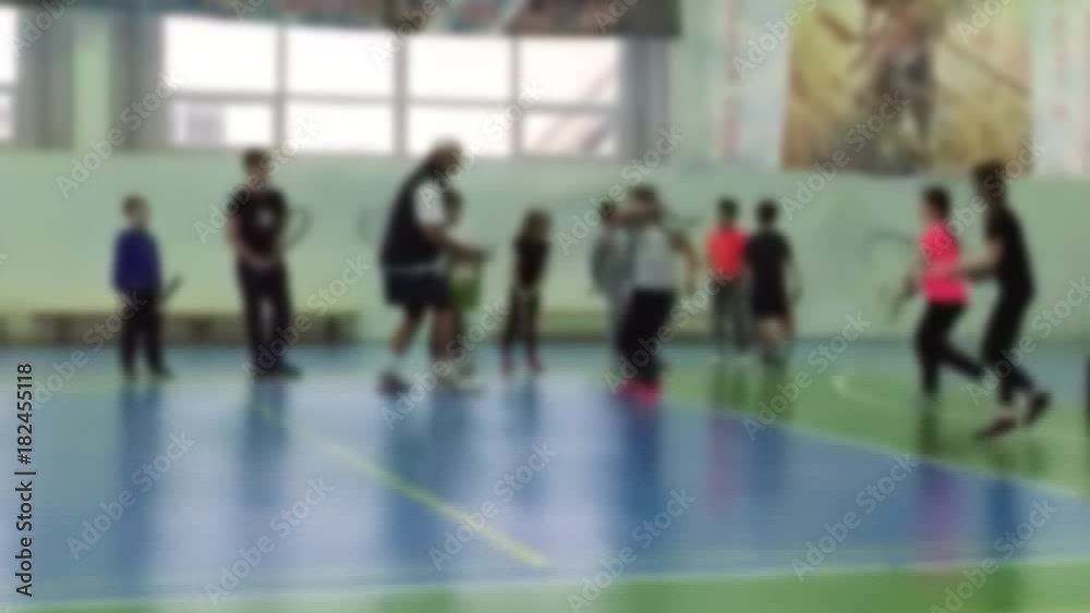 Young children kids background blur playing tennis at a clay court Young children kids background blur playing tennis at a clay court
