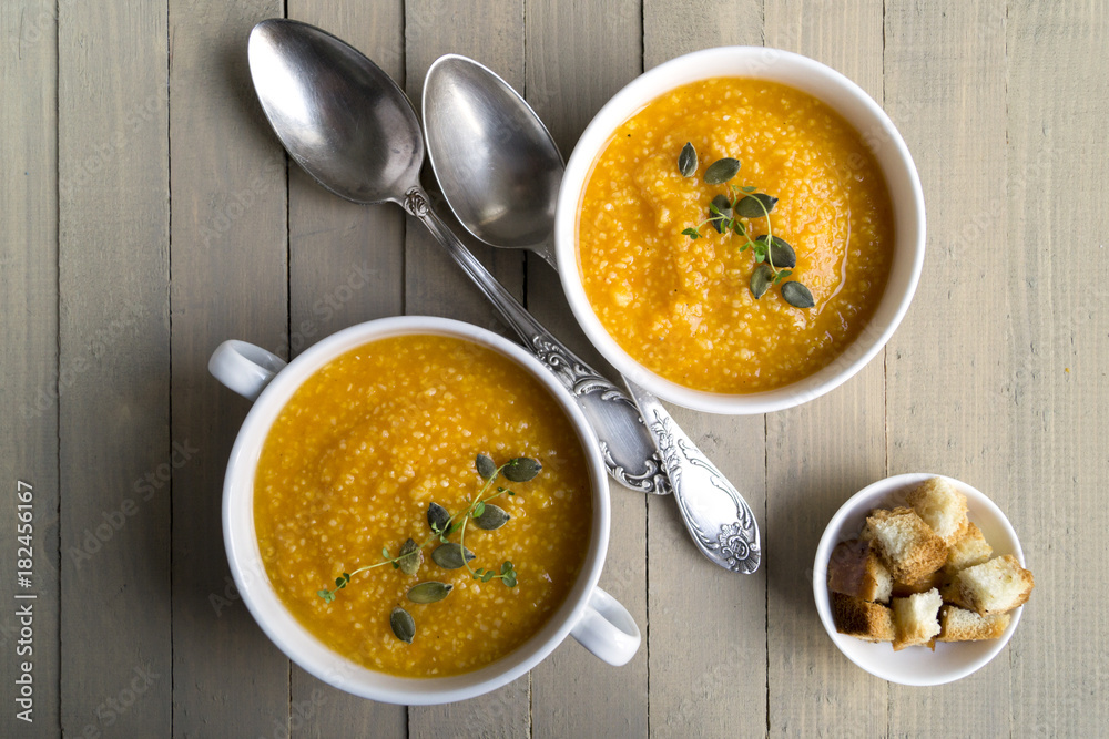 Vegetarian pumpkin soup on a wooden table.