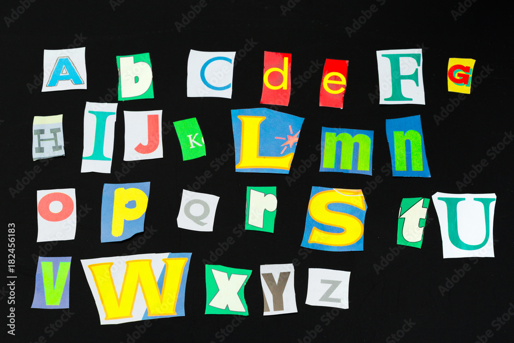 Colorful newspaper alphabet isolated on black