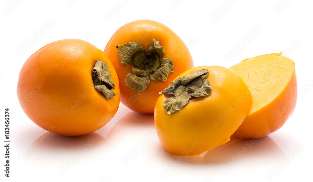 Persimmon Kaki isolated on white background two whole two sliced halves. Persimmon Kaki isolated on white background two whole two sliced halves.