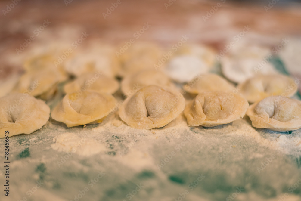 Female hands make home dumplings, close-up. Female hands make home dumplings, close-up.