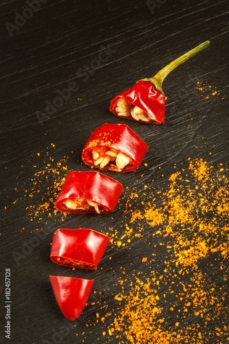 Chili pepper on a black wooden board. Dried healthy spices. Spicy food.