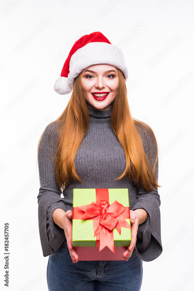 Happy excited young woman in santa claus hat with gift box over white background Happy excited young woman in santa claus hat with gift box over white background