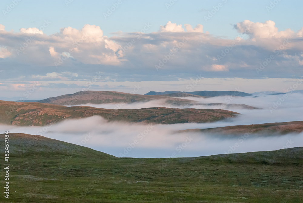 Fog on the hills at sunset, Soroya island, Norway