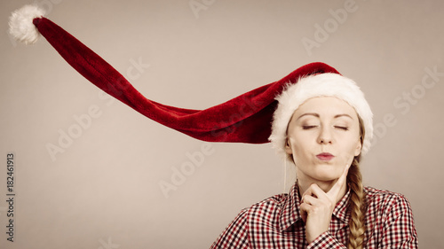 Funny girl wearing blowing santa claus hat