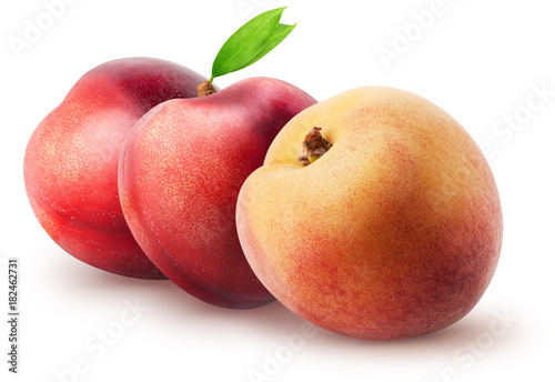 Two whole nectarine fruits and peach with leaves isolated on white background with clipping path