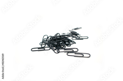 Clip for office accessories. Stationery. Black clips in a chaotic order.