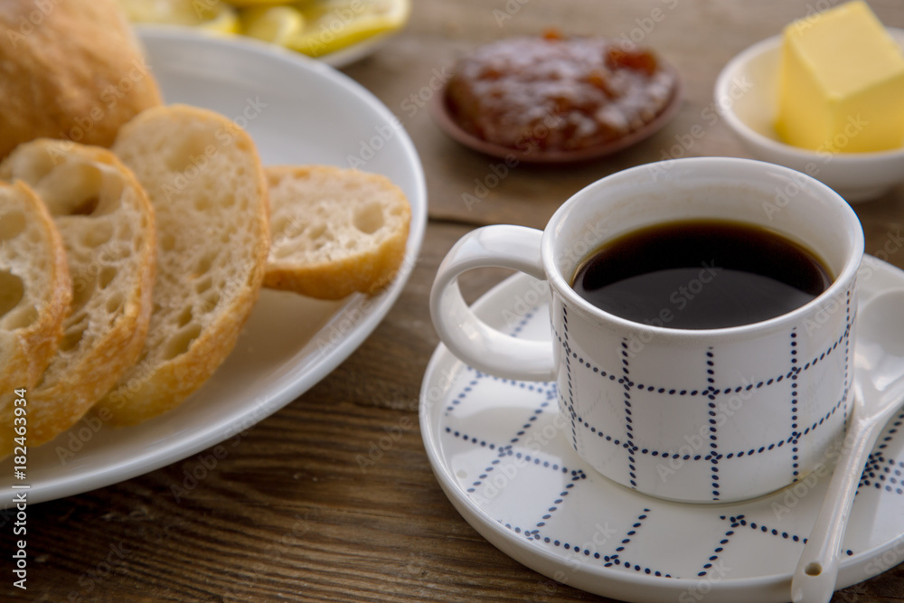 Breakfast with traditional French bread and cup of coffee. Breakfast with traditional French bread and cup of coffee.