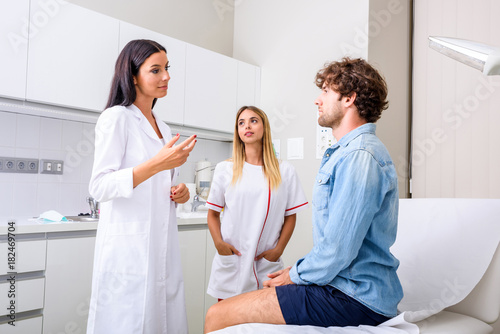 A young male patient in the emergency room with doctor and a nur